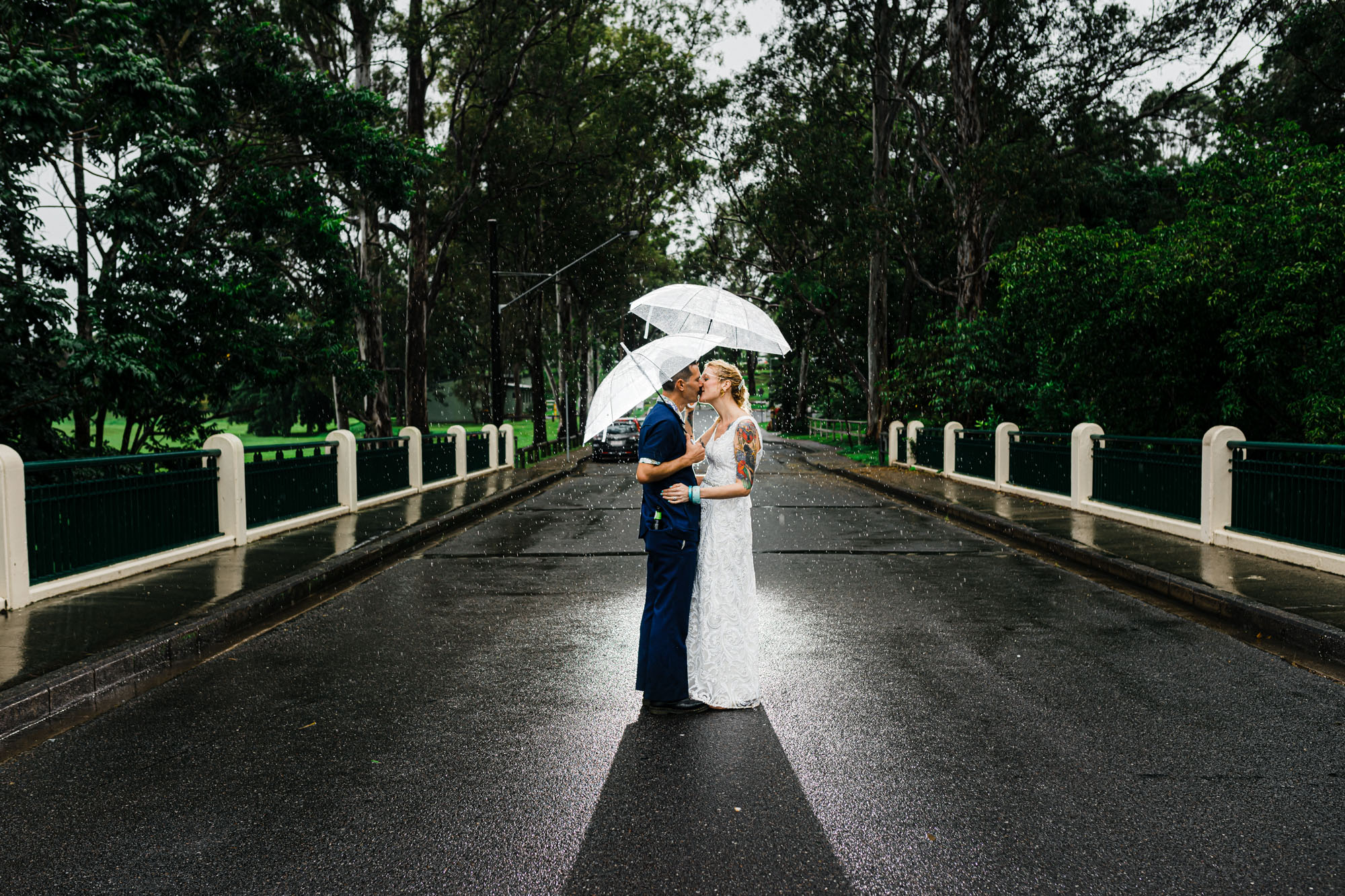 wedding photos on bridge in rain